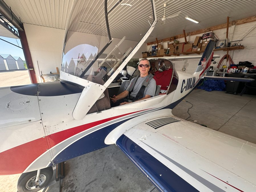 Randy seated in a light aircraft cockpit