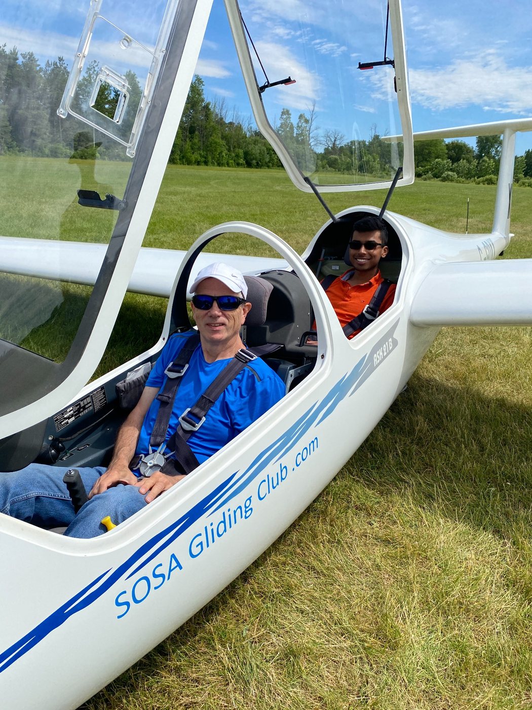 Randy seated in a glider with an instructor