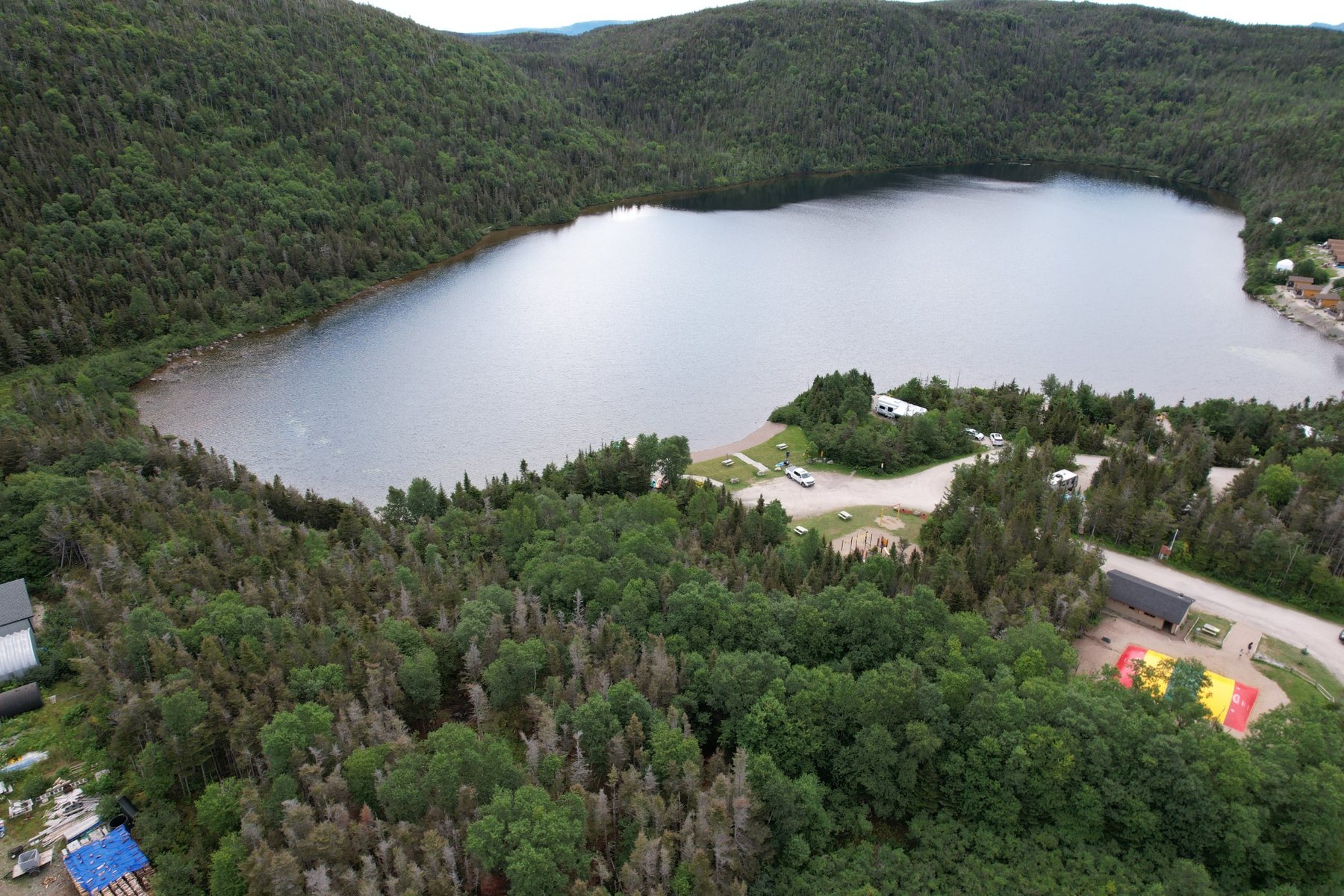 Aerial drone view of a lake and forested landscape at Gros Morne